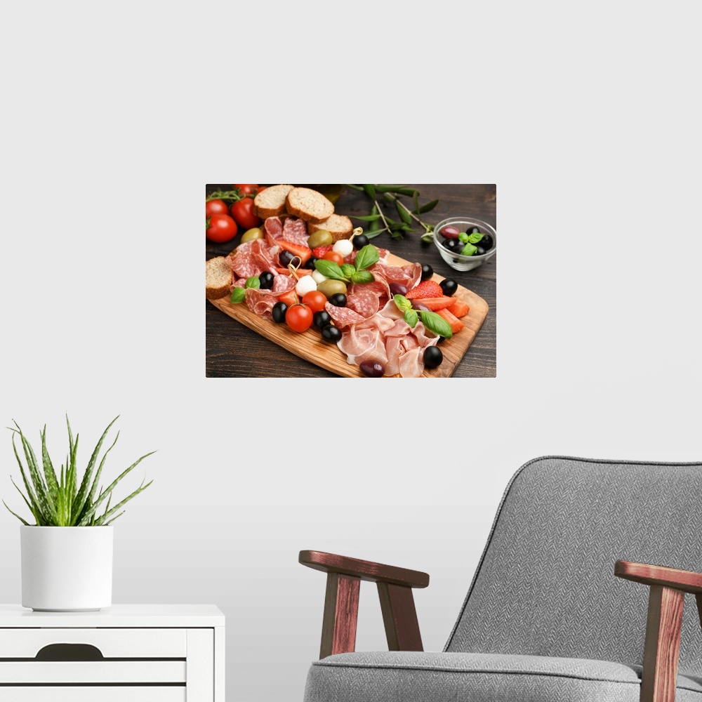 A modern room featuring Charcuterie board salami, prosciutto, with green and black olives, appetizers with mozzarella bal...