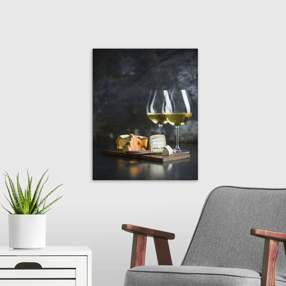 A modern room featuring Cheese platter and white wine.