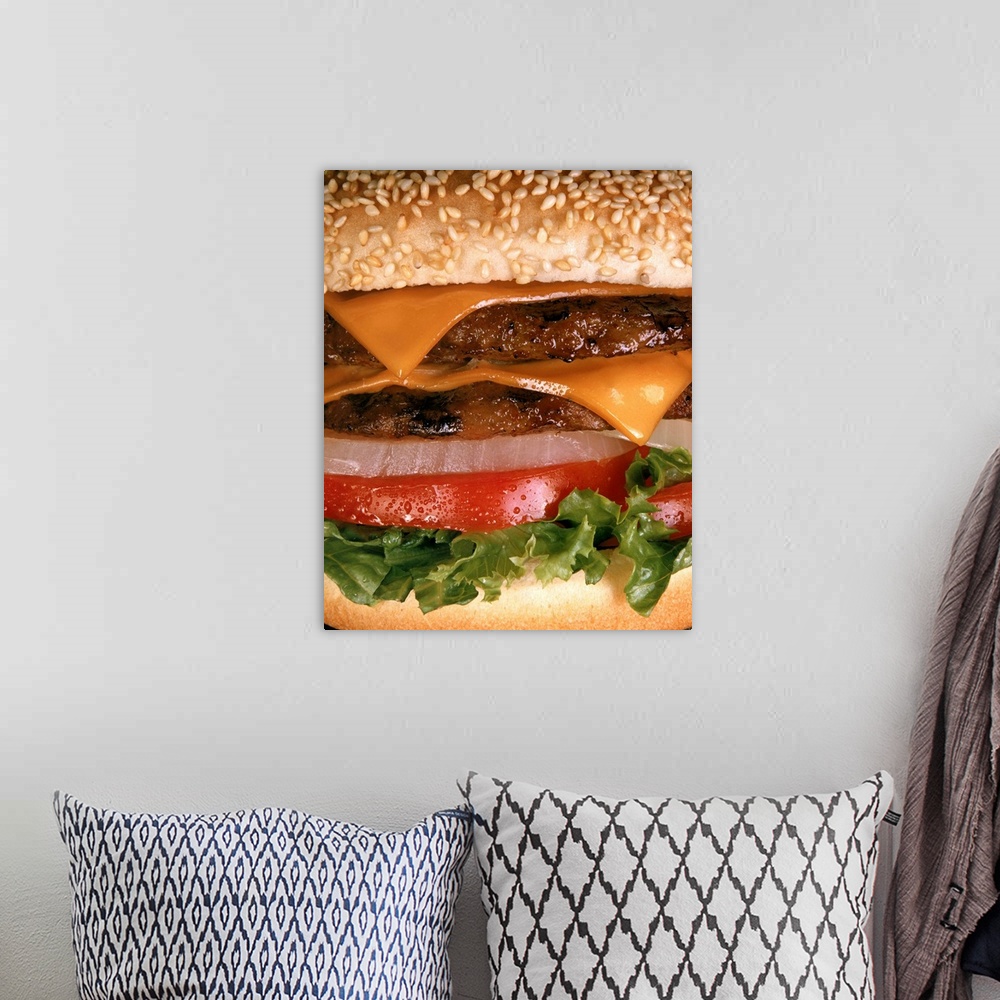 A bohemian room featuring Big vertical close up photograph of a  juicy tow layered cheeseburger with onion, tomato and lett...