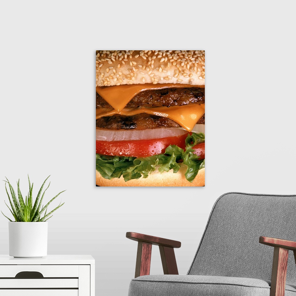 A modern room featuring Big vertical close up photograph of a  juicy tow layered cheeseburger with onion, tomato and lett...