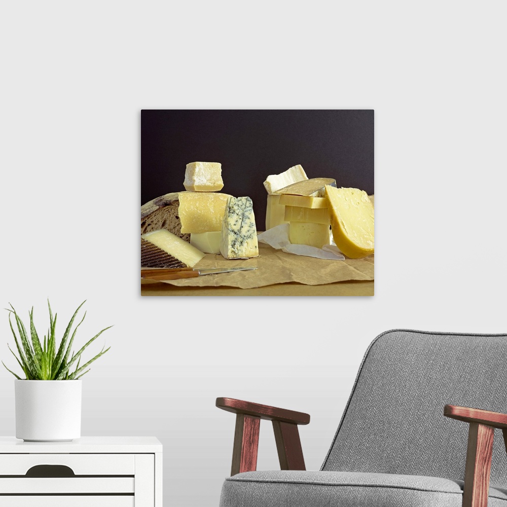 A modern room featuring Cheeses and bread on block with knives