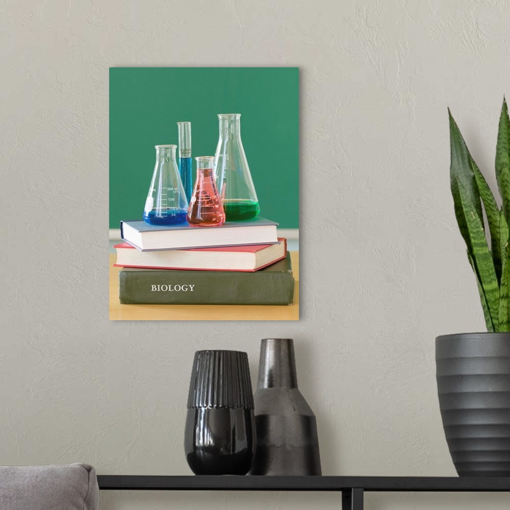 A modern room featuring Chemistry beakers and stack of books