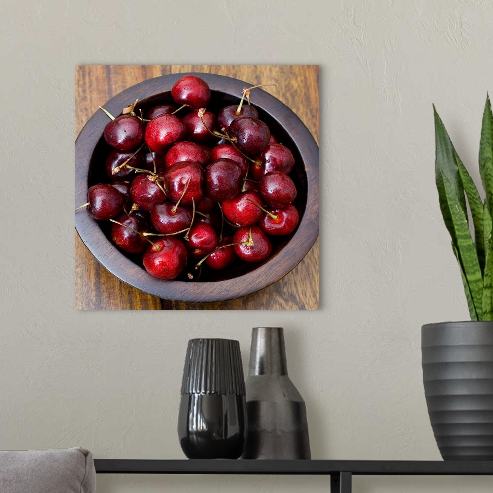 A modern room featuring Cherries in wooden bowl
