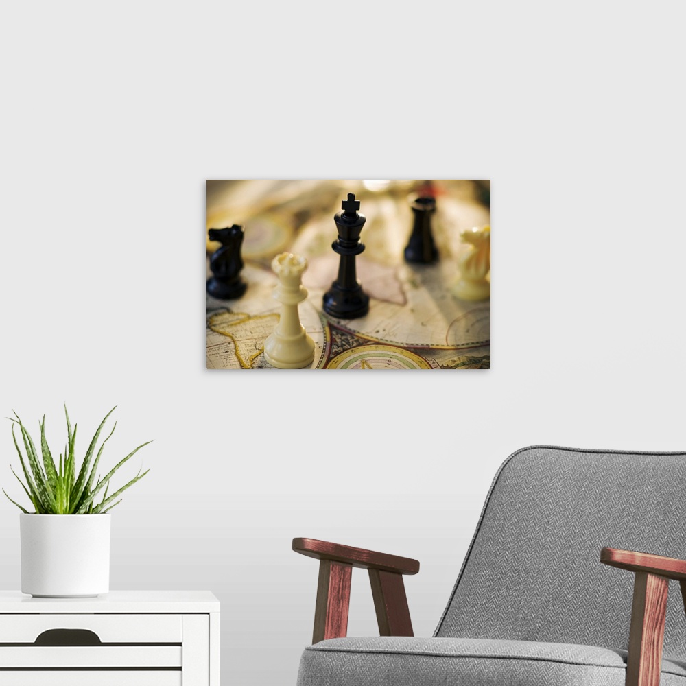 A modern room featuring Chess pieces on old world map