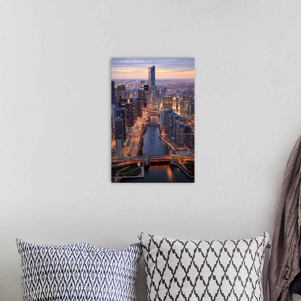 A bohemian room featuring Vertical panoramic photograph of city skyline at dusk.  Building lights are shining and there is ...