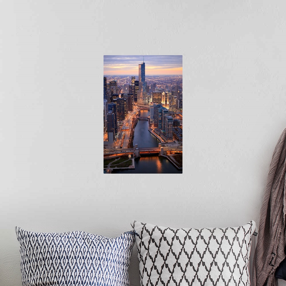 A bohemian room featuring Vertical panoramic photograph of city skyline at dusk.  Building lights are shining and there is ...