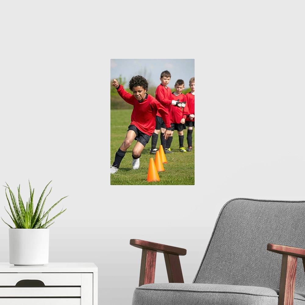 A modern room featuring Children playing Soccer