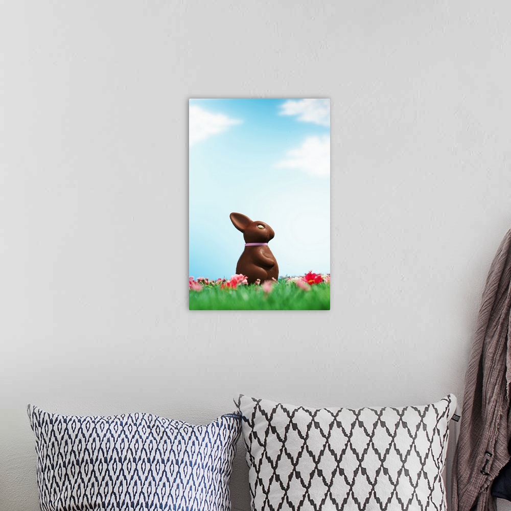 A bohemian room featuring Chocolate Easter bunny amongst flowers in grass, side view