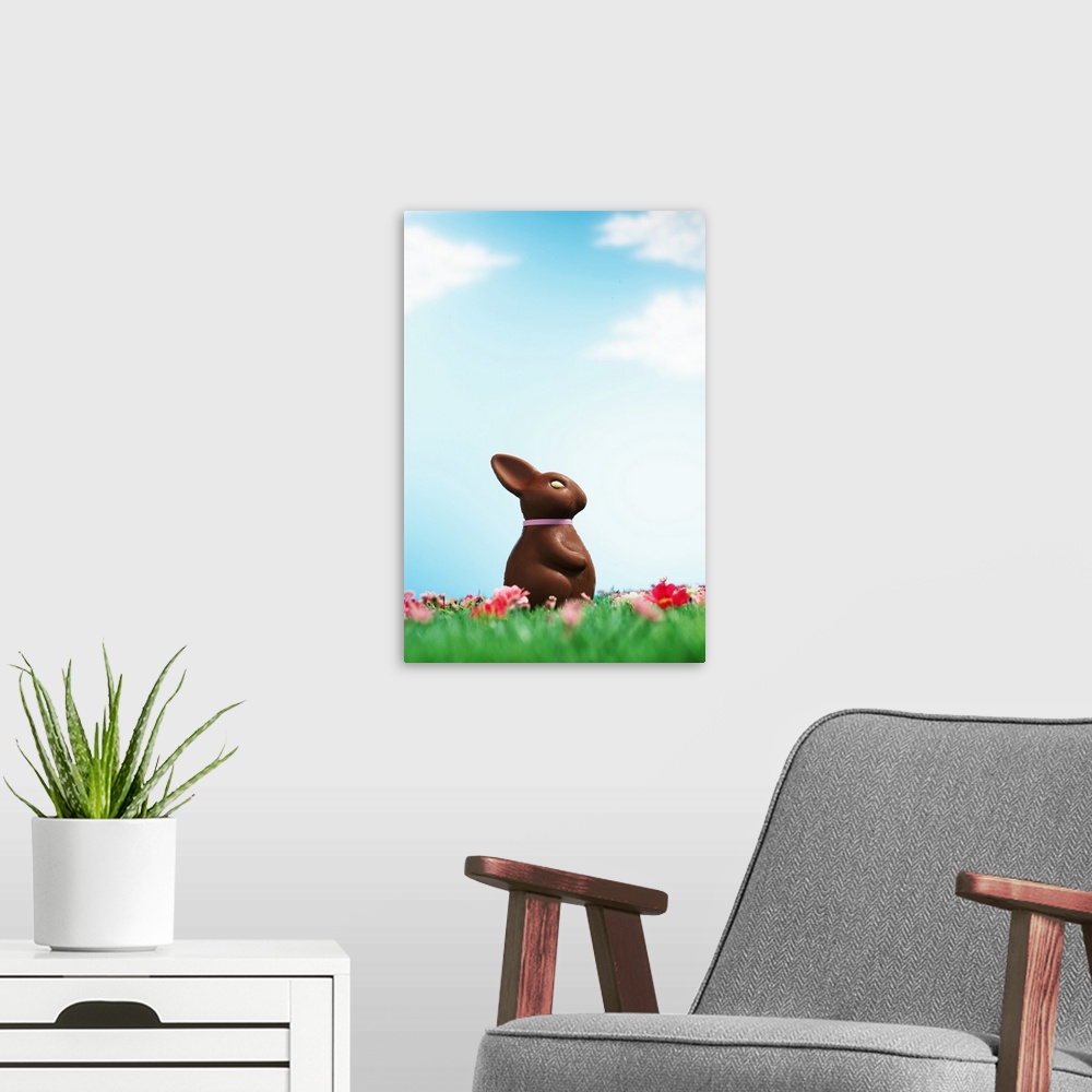 A modern room featuring Chocolate Easter bunny amongst flowers in grass, side view