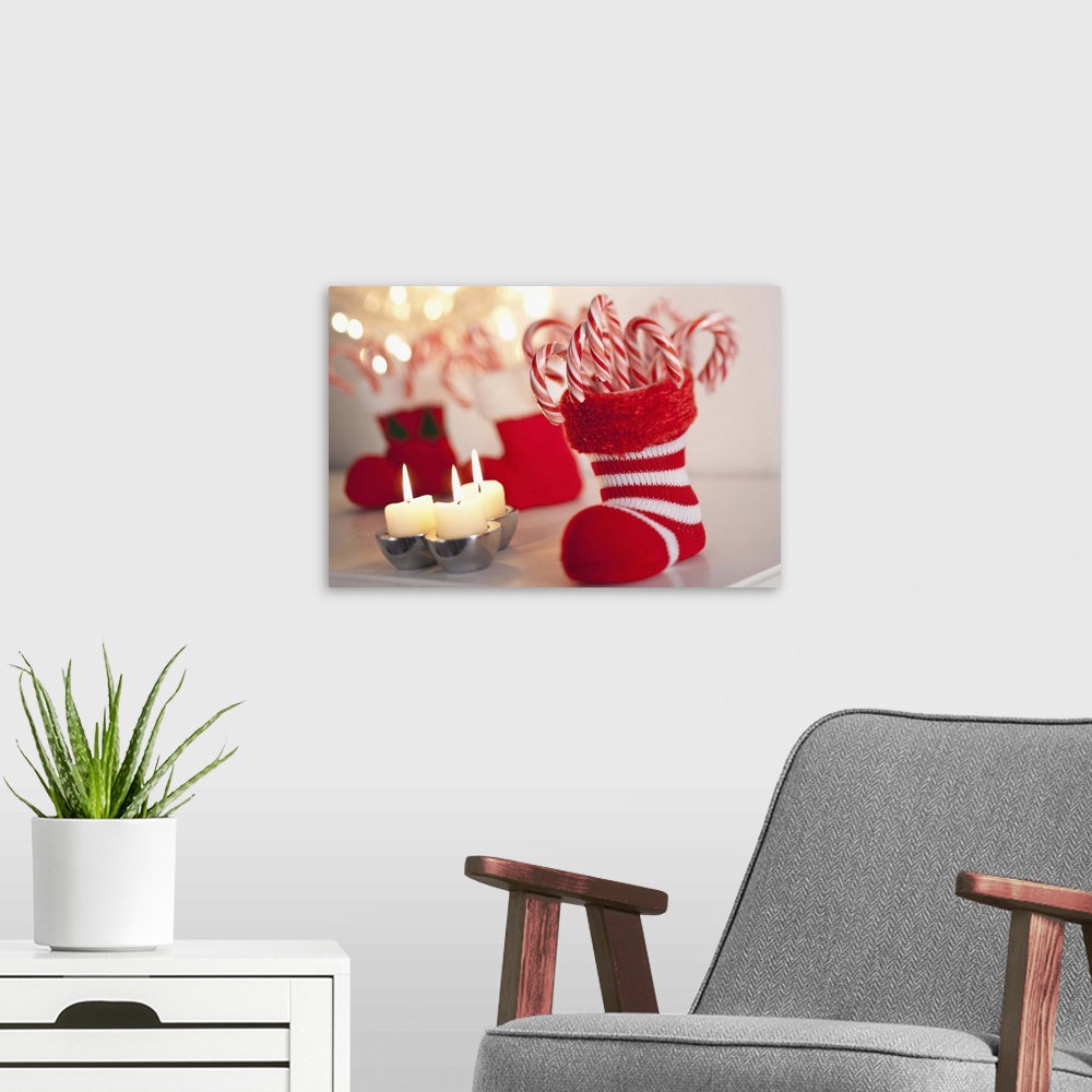A modern room featuring christmas candy caine in stocking with candles