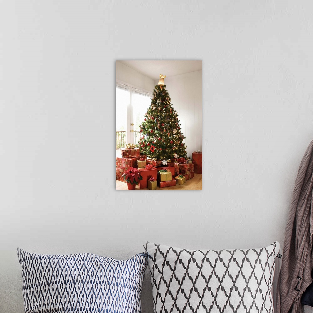 A bohemian room featuring Christmas tree and gifts