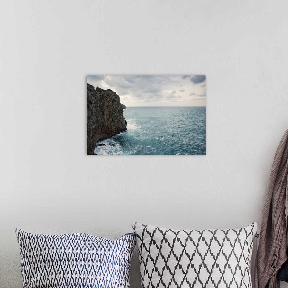 A bohemian room featuring Cliff line and blue wild stormy Mediterranean sea, Mallorca.