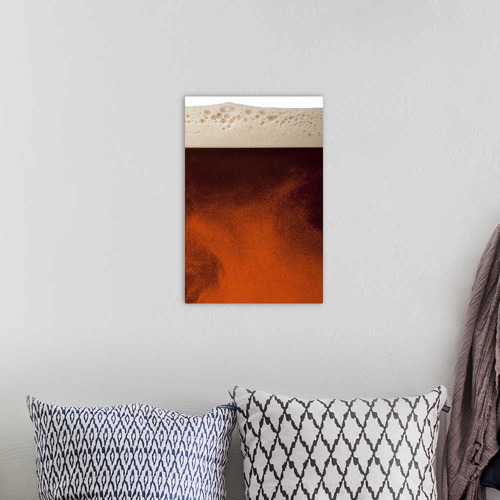 A bohemian room featuring Close up image of amber colored beer with frothy head, swirling bubbles and copy space