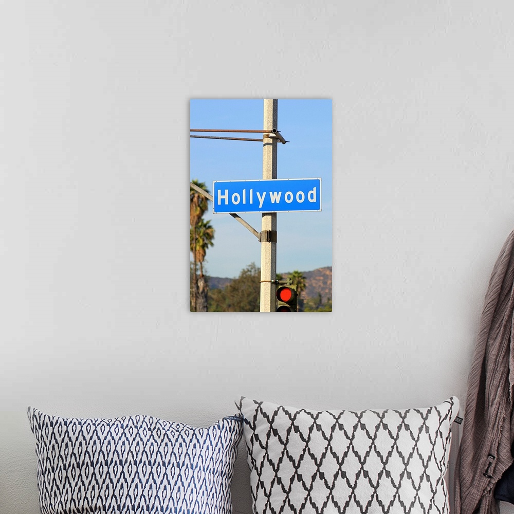 A bohemian room featuring Close-up of a blue street sign on a lamppost for Hollywood.