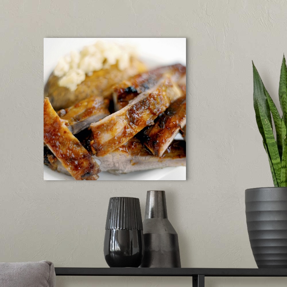 A modern room featuring Close-up of a dish of mashed potato and spare ribs