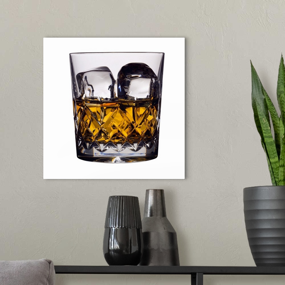 A modern room featuring Close up of a glass of whiskey and ice