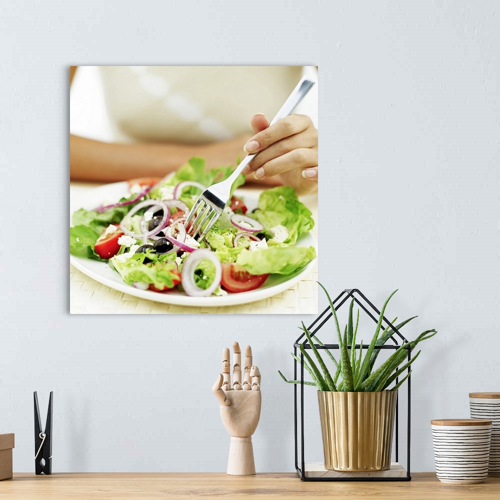 A bohemian room featuring Close-up of a person eating salad with a fork