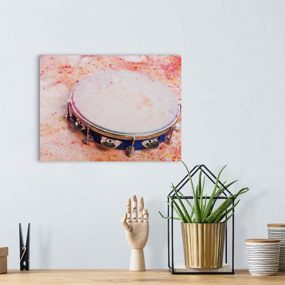 A bohemian room featuring Close-up of a tambourine with Holi colors
