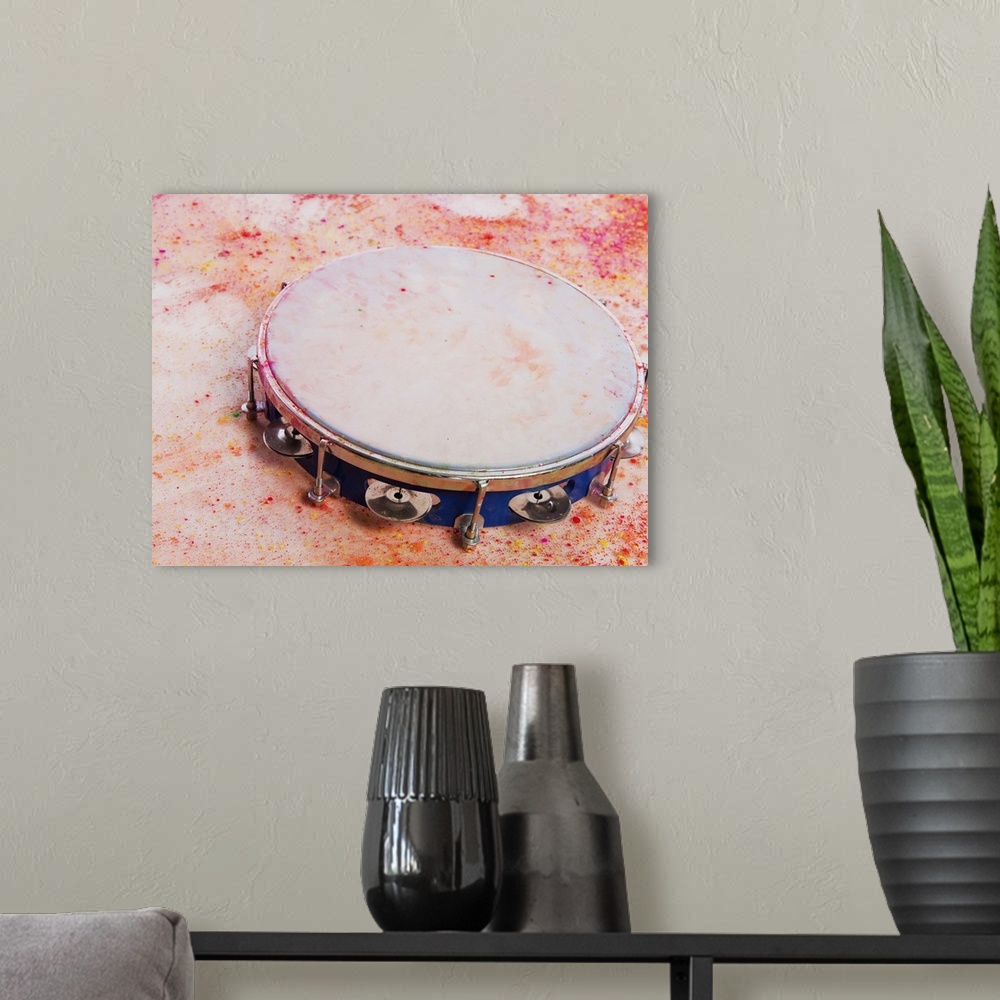 A modern room featuring Close-up of a tambourine with Holi colors