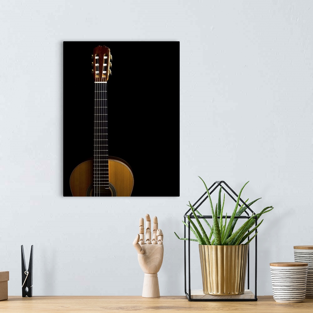 A bohemian room featuring Close-up of acoustic guitar on black