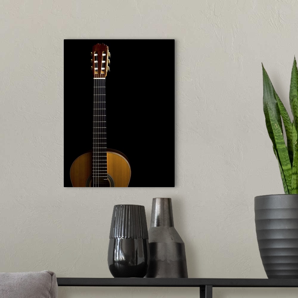 A modern room featuring Close-up of acoustic guitar on black