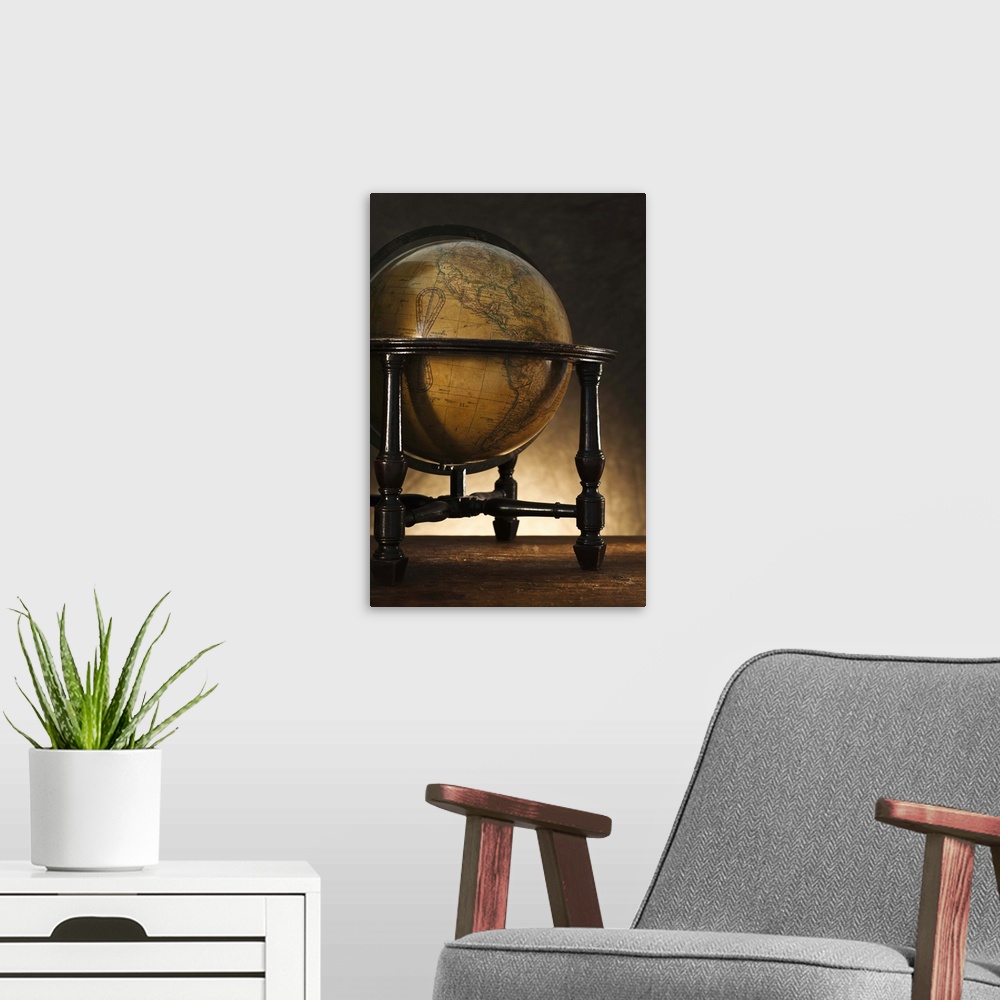 A modern room featuring Close up of antique globe on table