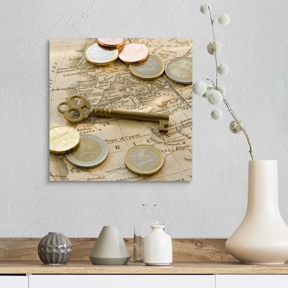A farmhouse room featuring Close up of euro coins, map and antique key