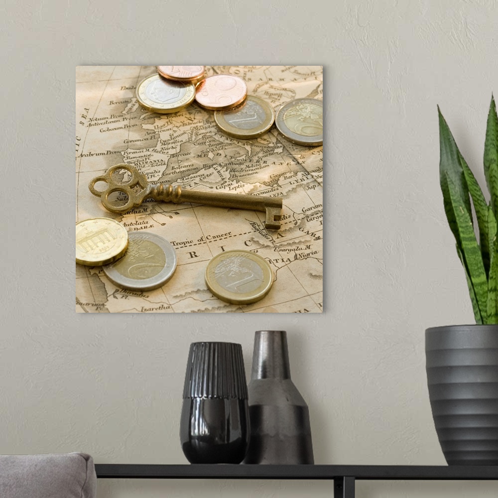 A modern room featuring Close up of euro coins, map and antique key