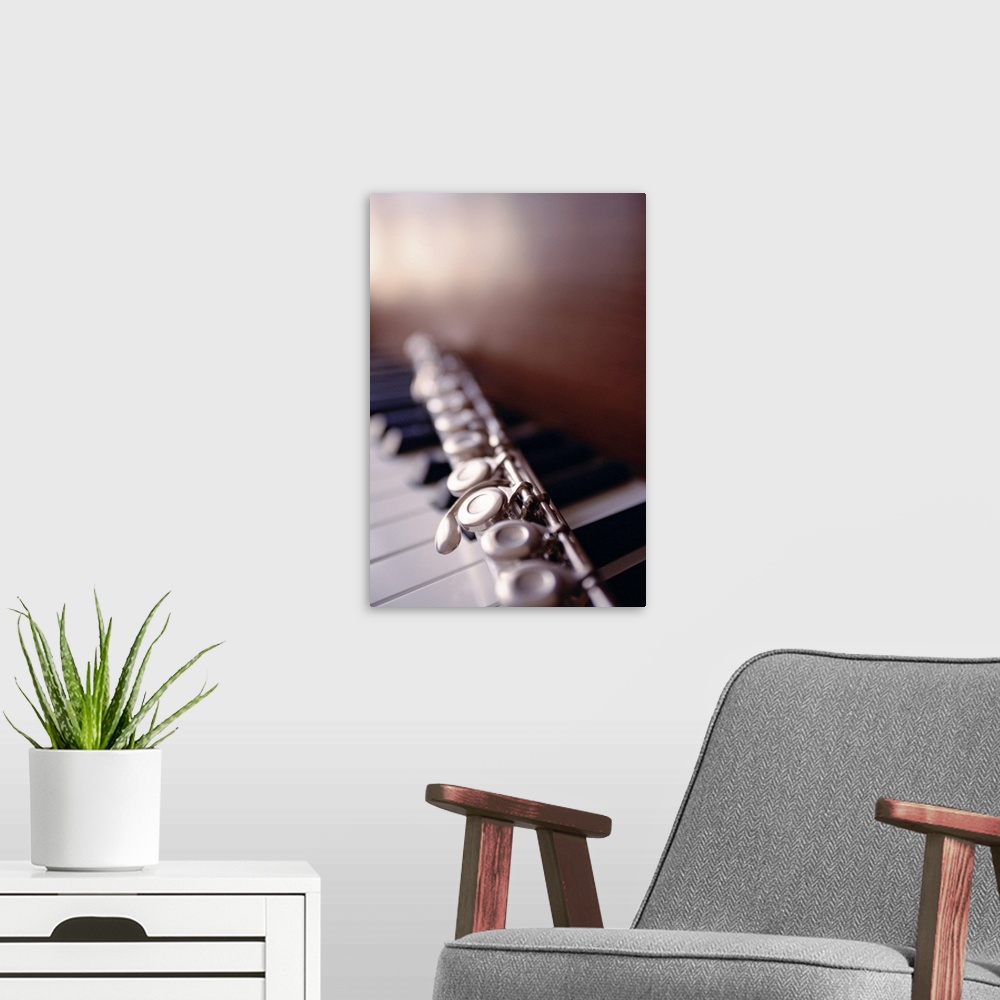 A modern room featuring Close-up of flute on piano keys
