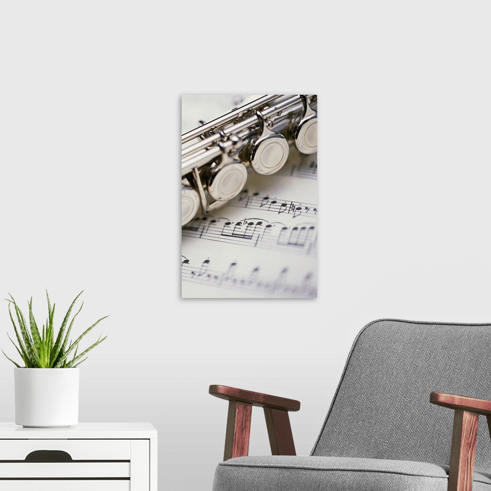 A modern room featuring Close-up of flute on sheet music