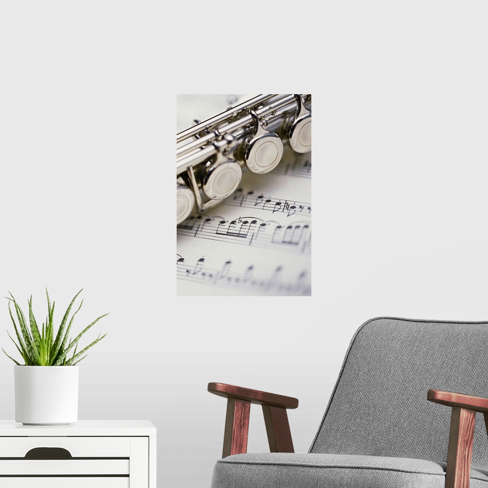 A modern room featuring Close-up of flute on sheet music