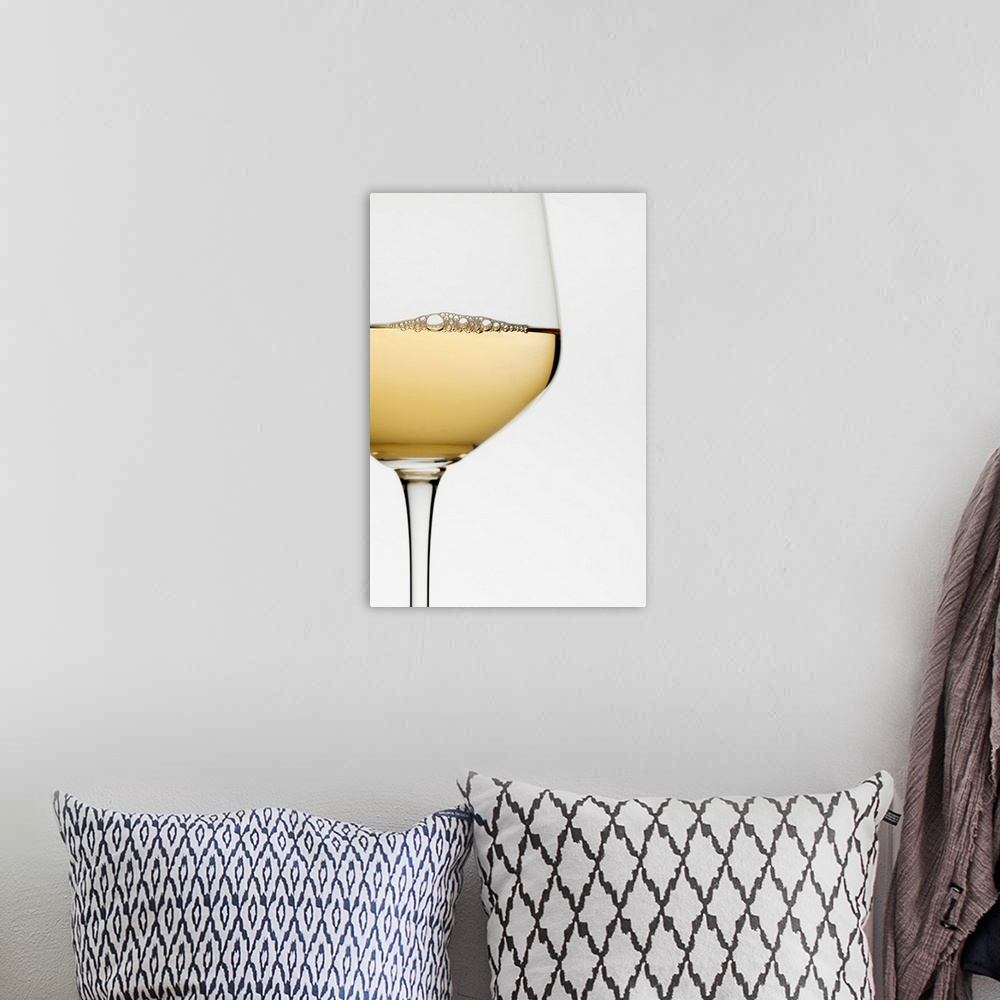 A bohemian room featuring Close up of glass of white wine on white background