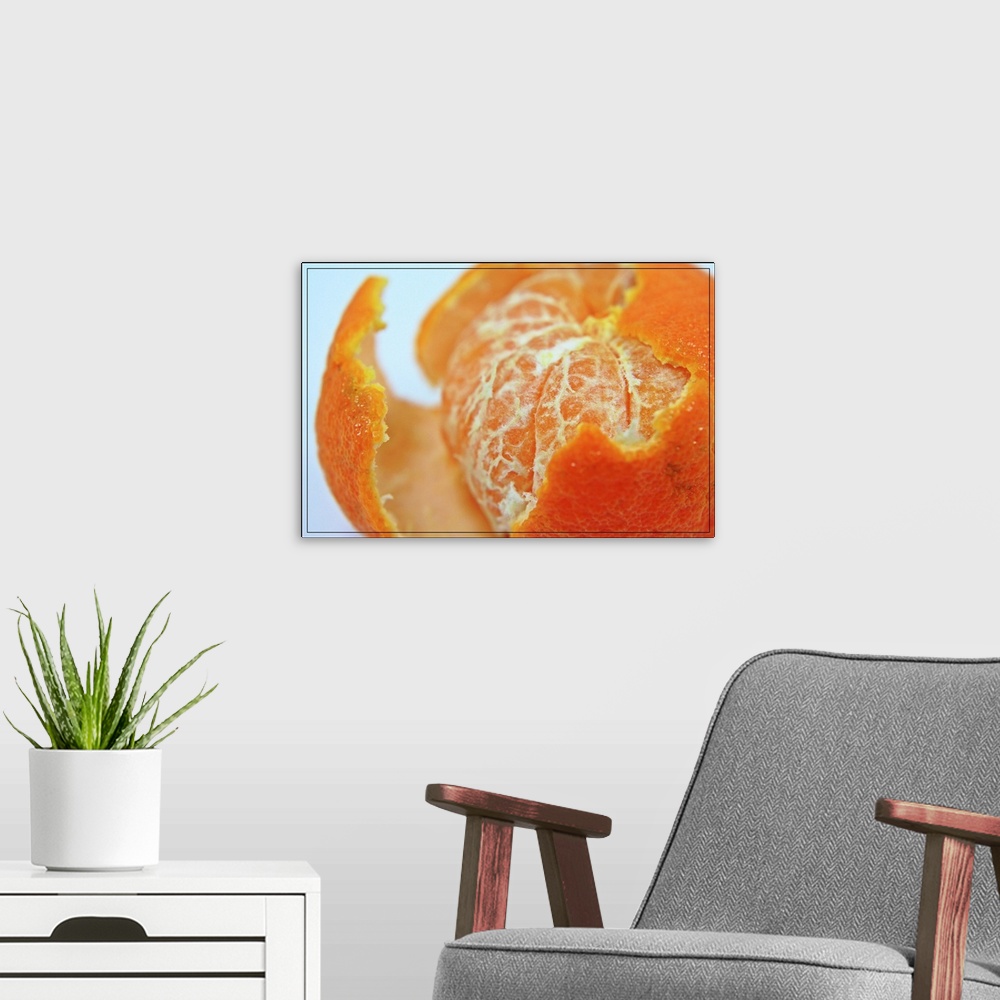 A modern room featuring Close up of partly peeled juicy orange.