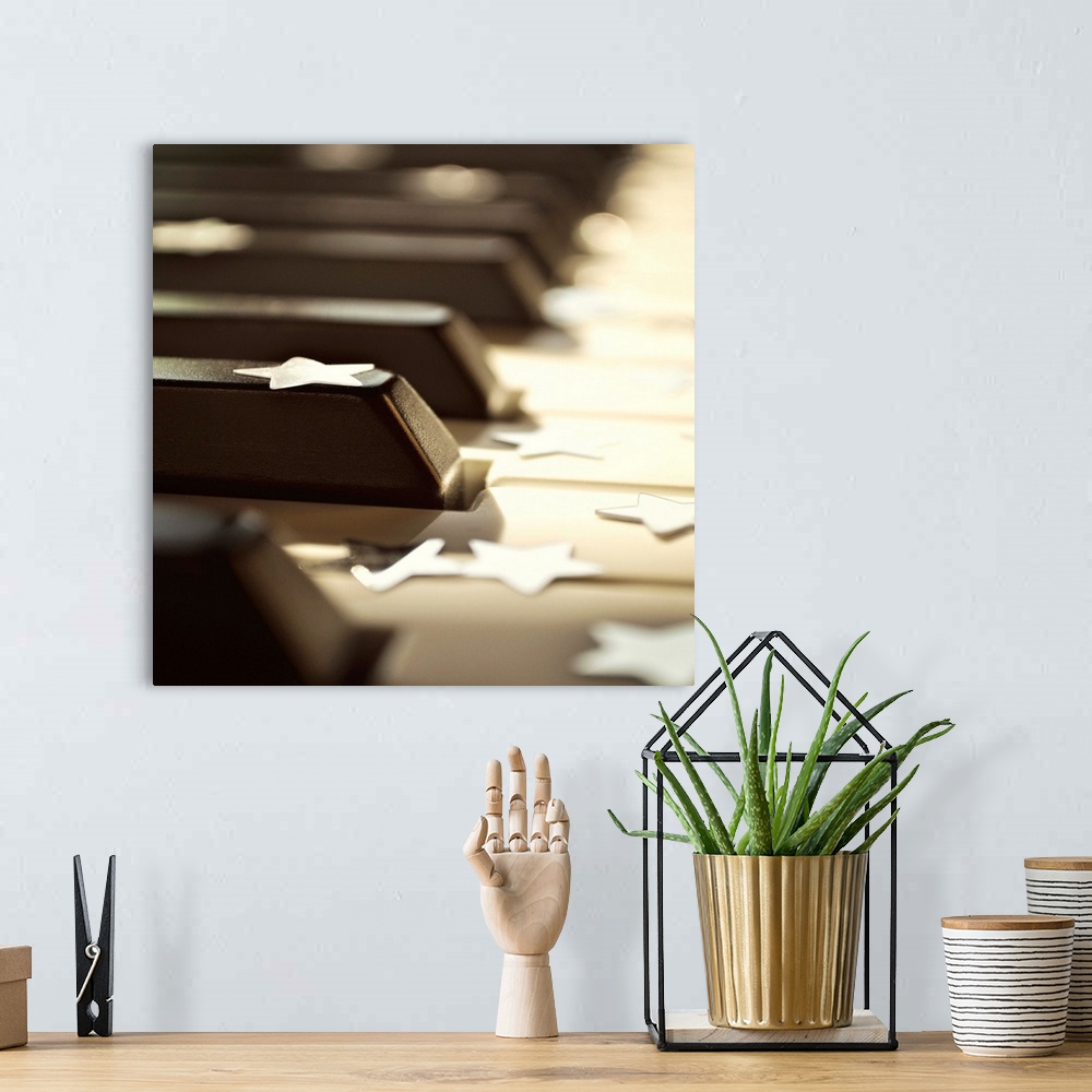 A bohemian room featuring Close up of piano keys with stars.