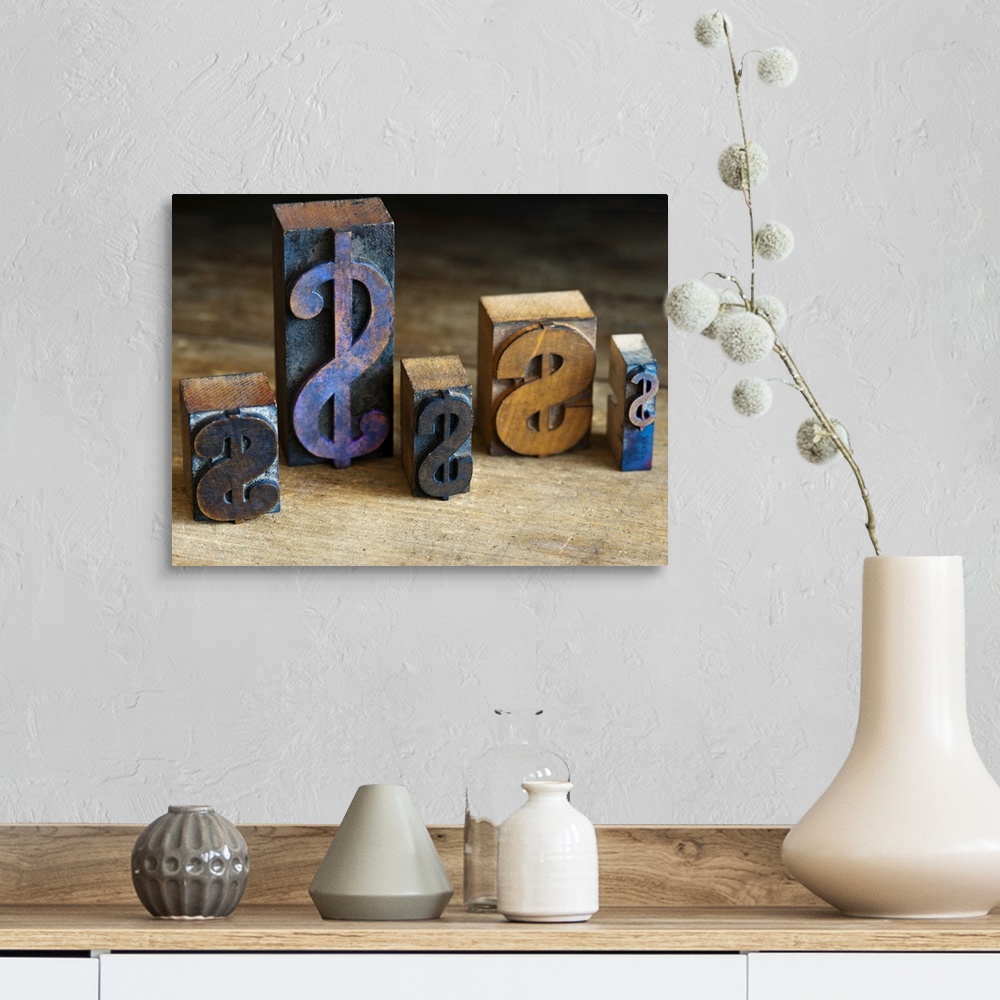 A farmhouse room featuring Close up of printing blocks with dollar sign on wood