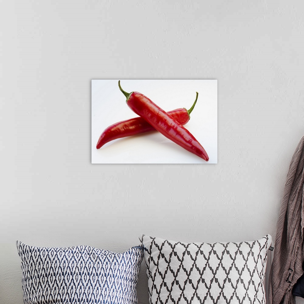 A bohemian room featuring Close up of red chili peppers on white background