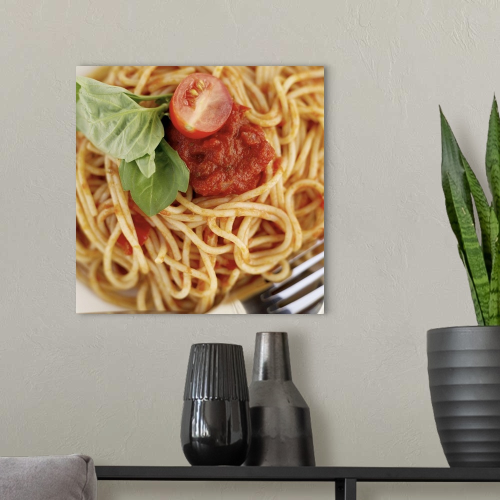 A modern room featuring close-up of spaghetti garnished with basil