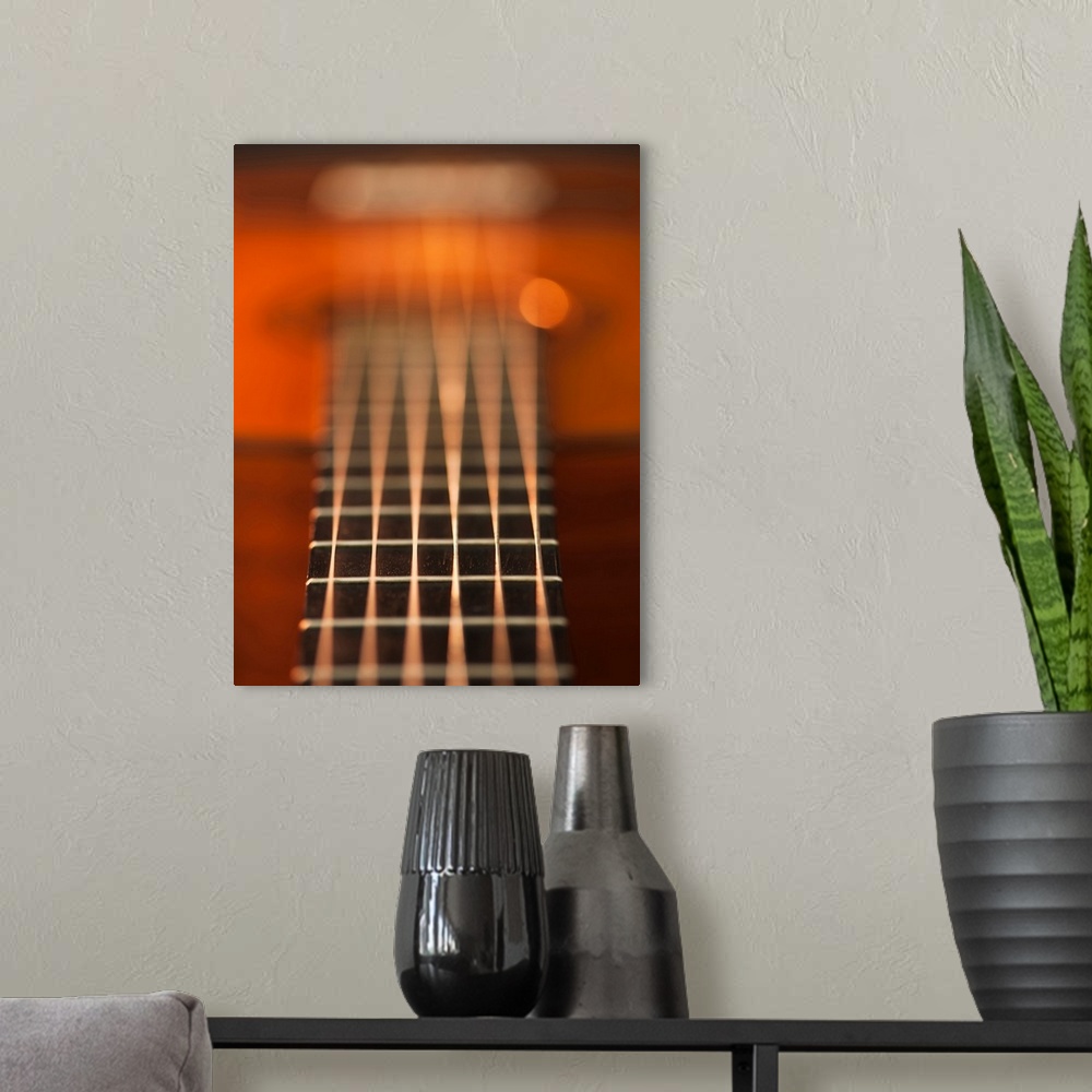 A modern room featuring Close up of strings of acoustic guitar
