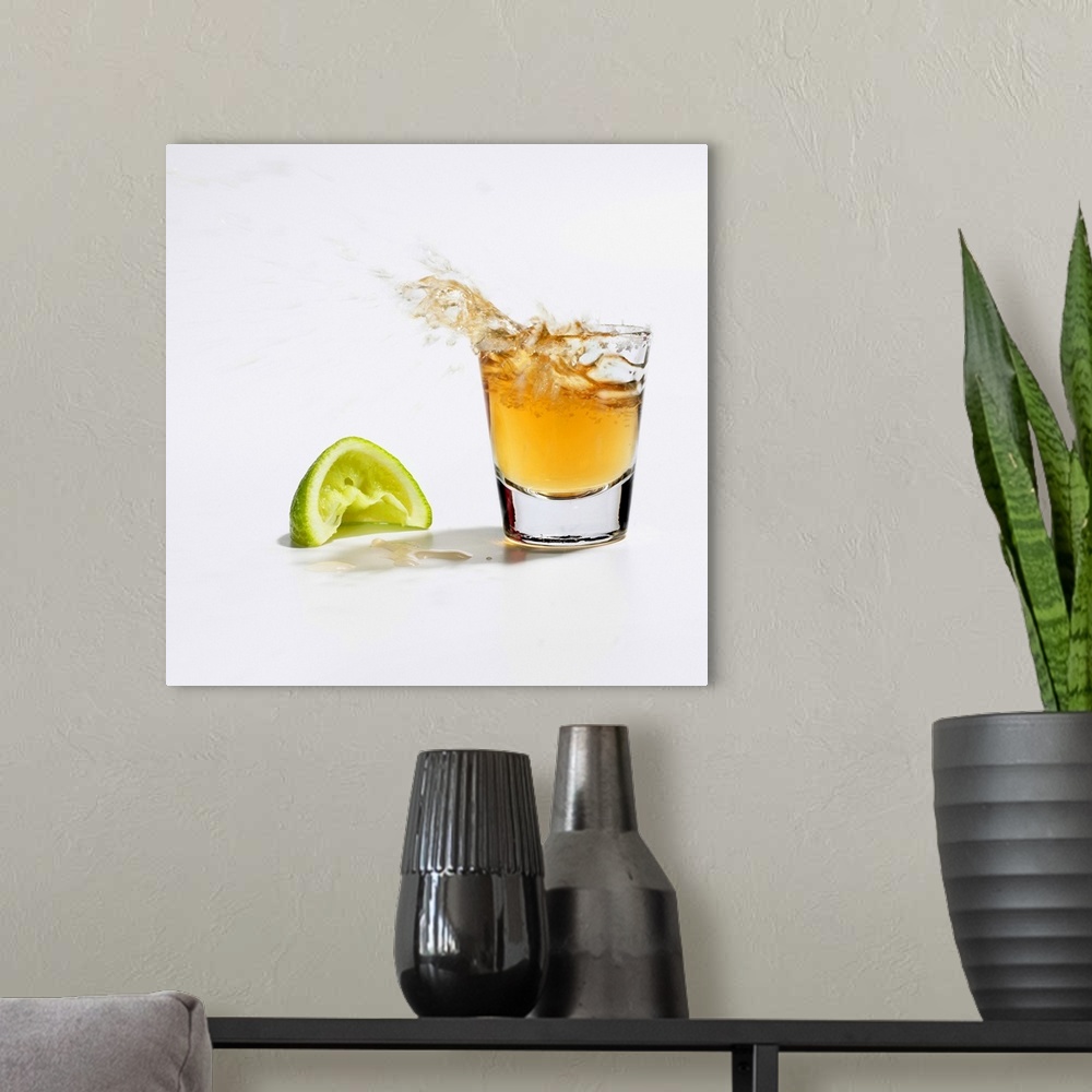 A modern room featuring Close up of tequila splashing out of glass