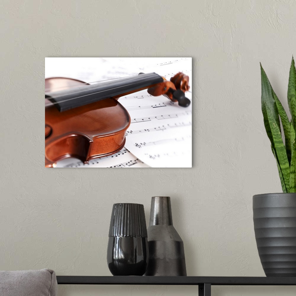 A modern room featuring Close up of violin and sheet music