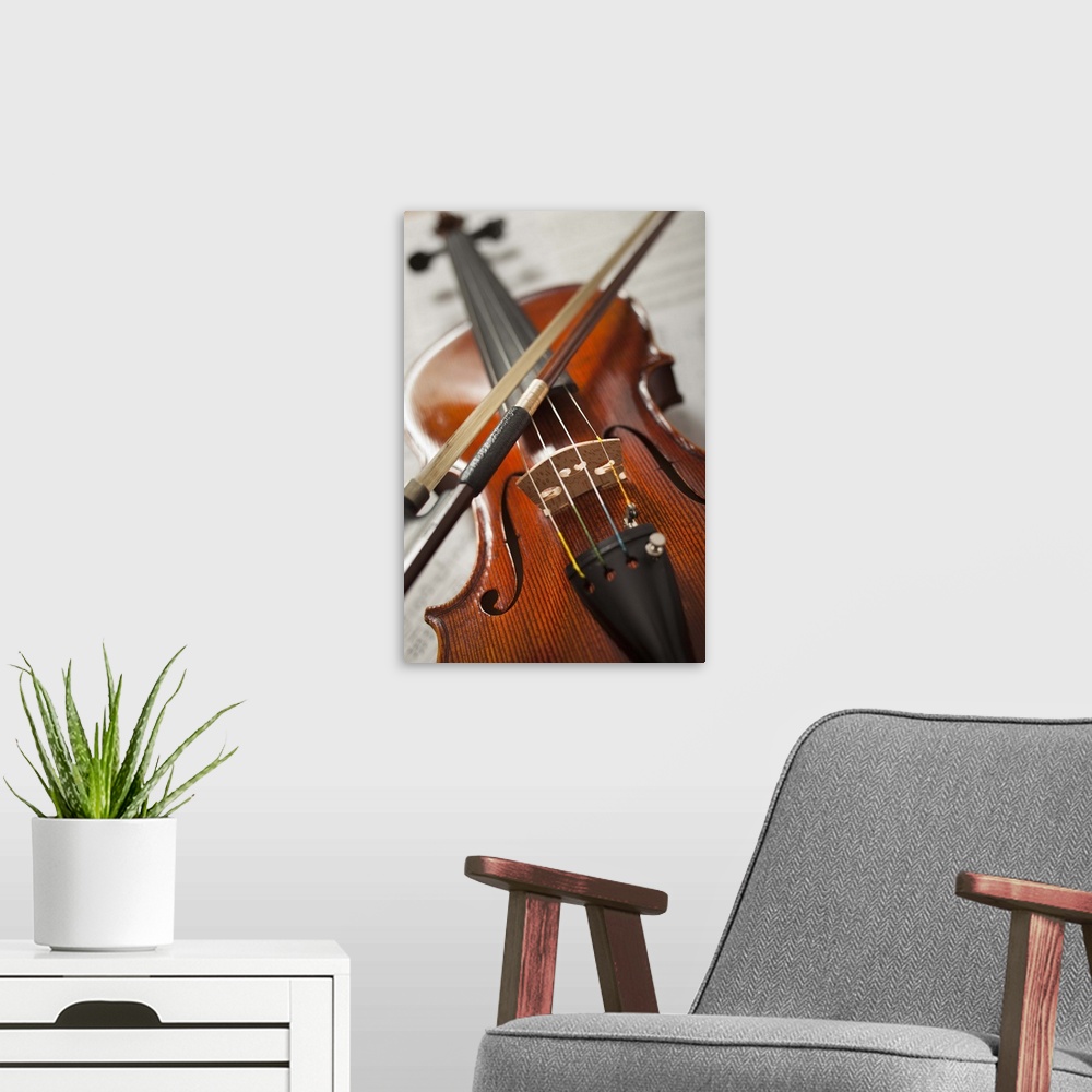 A modern room featuring Close-up of violin on sheet music