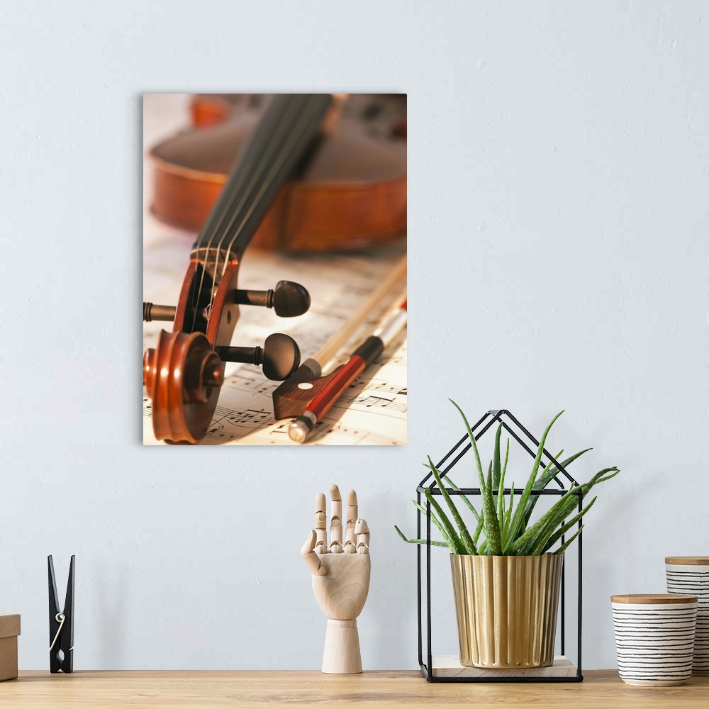 A bohemian room featuring Close up of violin scroll and bow on sheet music