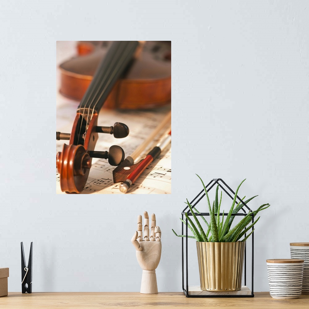A bohemian room featuring Close up of violin scroll and bow on sheet music