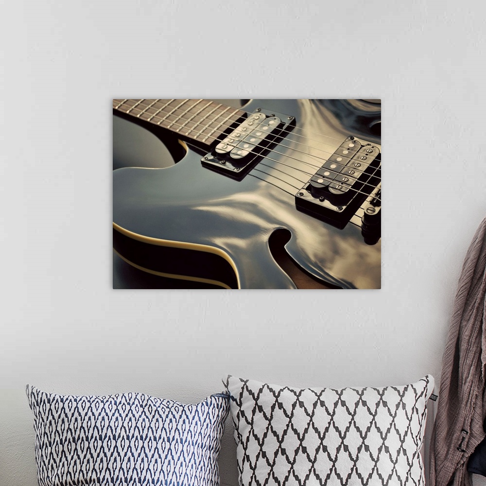 A bohemian room featuring Close up shot of black guitar.