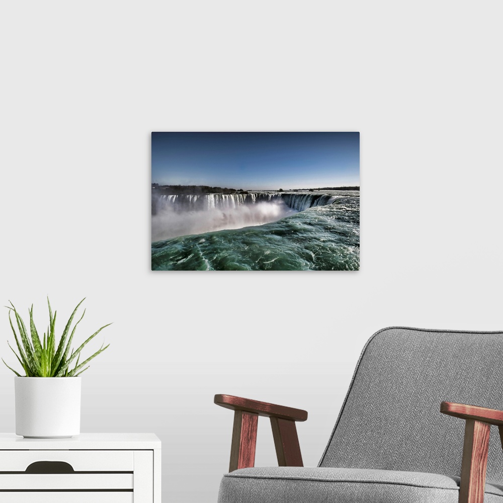 A modern room featuring Close up view of clear water of Horseshoe waterfalls in Canadian side of Niagara Falls.