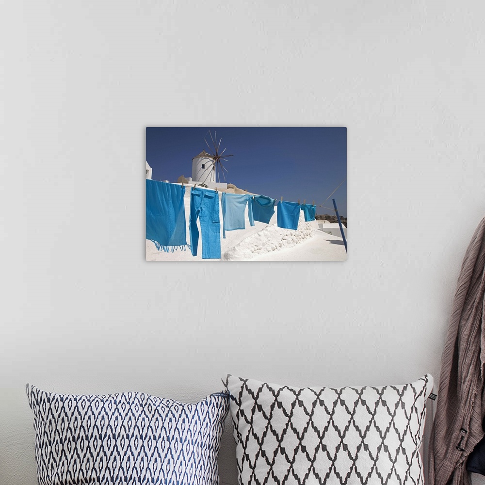 A bohemian room featuring Greece, Santorini, Oia, clothes drying, windmill in background