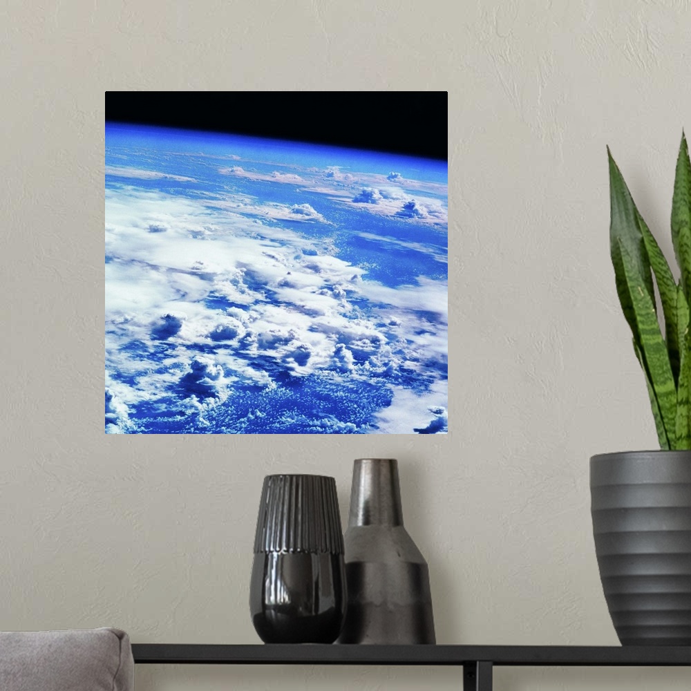 A modern room featuring Clouds over earth viewed from a satellite
