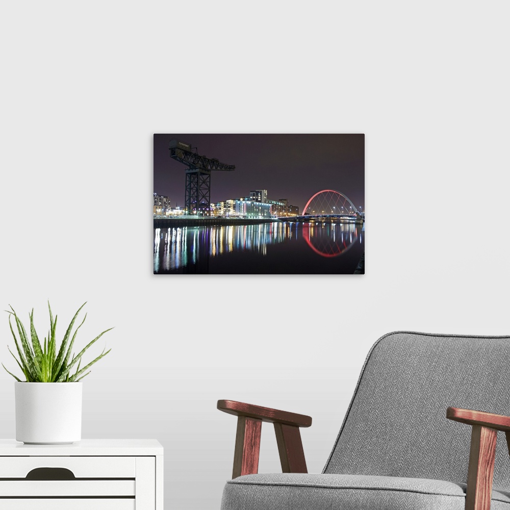 A modern room featuring View of Finnieston Crane and Clyde arc bridge on the River Clyde at night