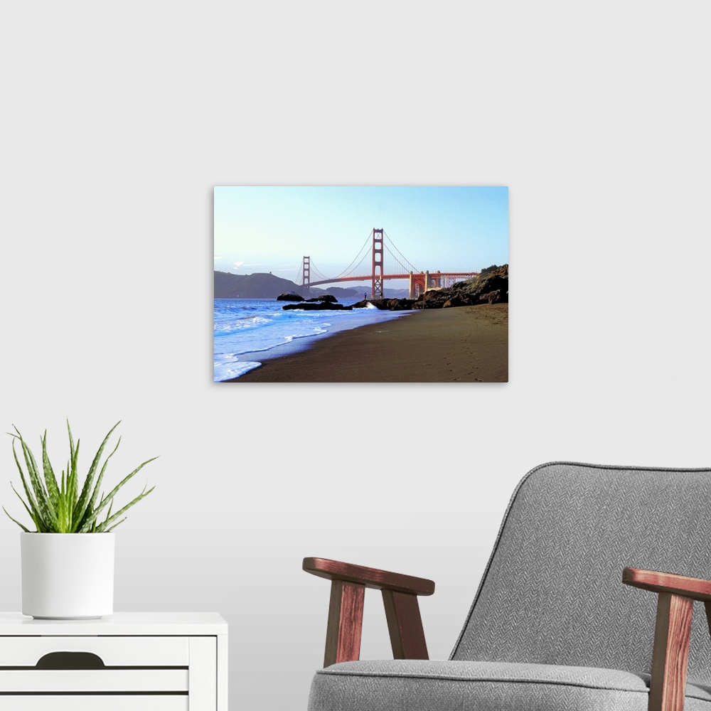 A modern room featuring Landscape photograph looking down the rocky shoreline toward the Golden Gate Bridge, beneath a bl...