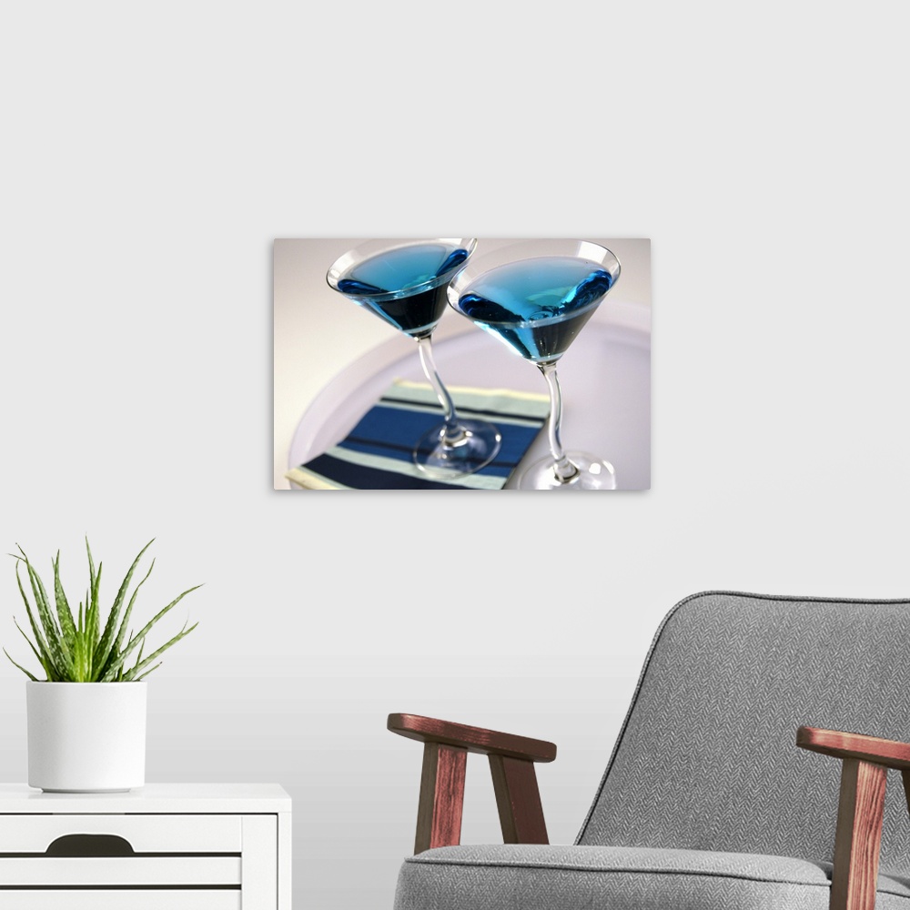 A modern room featuring Cocktail glasses containing blue drink, close up